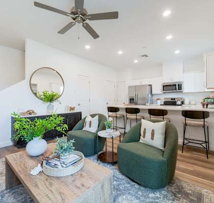 A living room with a green couch and a wooden coffee table.