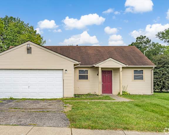 A house with a red door and a white garage door.