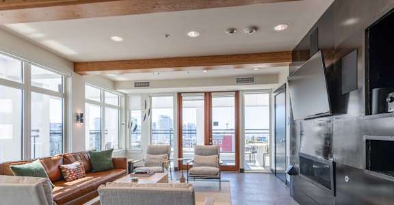 A modern living room with a fireplace and a view of the city.
