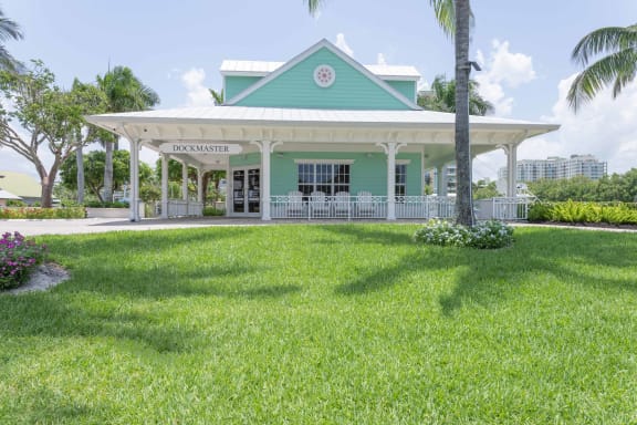 a building with a porch and a lawn in front of it