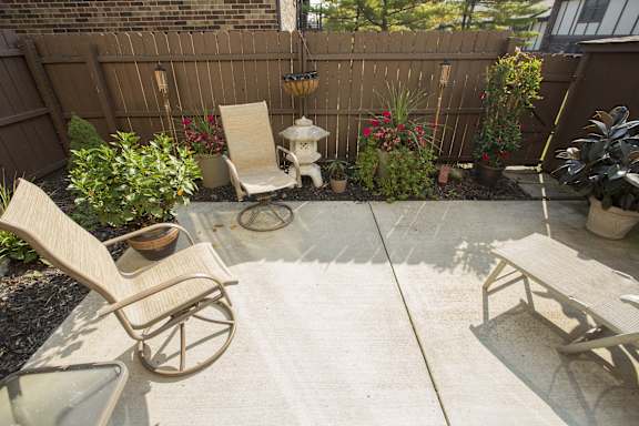 A patio with a chair and a table.