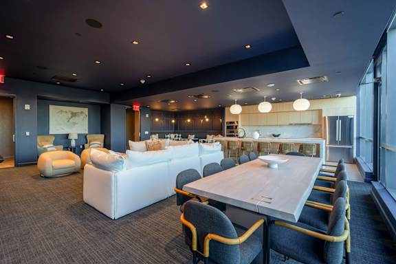 a living room and dining room with couches and a table