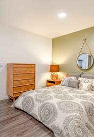 a bedroom with a bed and a dresser