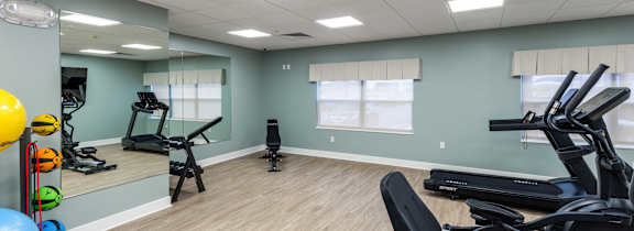 A spacious gym with a variety of exercise equipment.