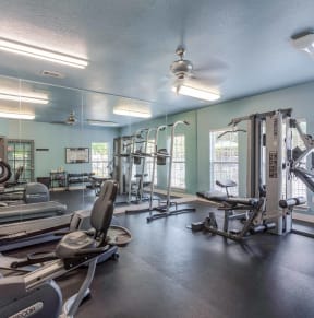 a gym with weights and cardio equipment at the estates apartments