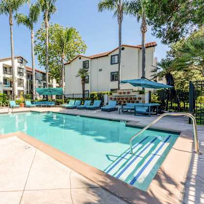 our apartments have a swimming pool with chairs and umbrellas