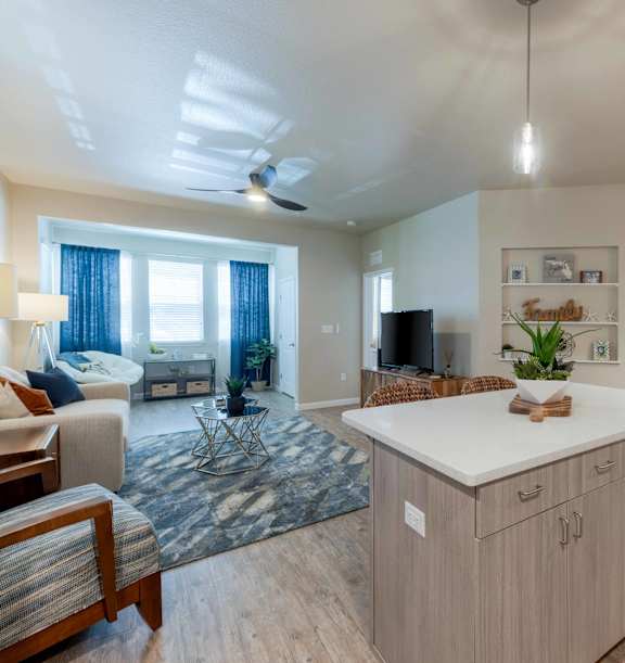 A living room with a white couch and a wooden entertainment center.