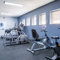 a gym with various exercise equipment in a building