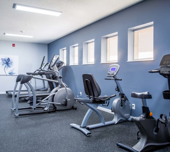 a gym with various exercise equipment in a building