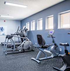 a gym with various exercise equipment in a building