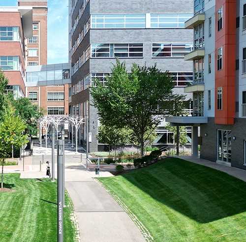 A walkway with a metal pole on the left side leads to a building. at Bakery Living, Pennsylvania, 15206