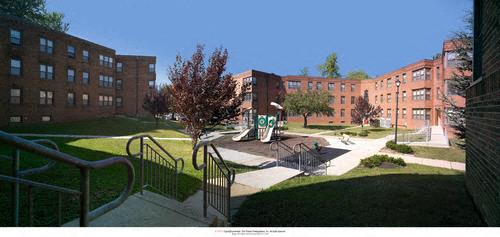 a view of a playground in front of a brick building