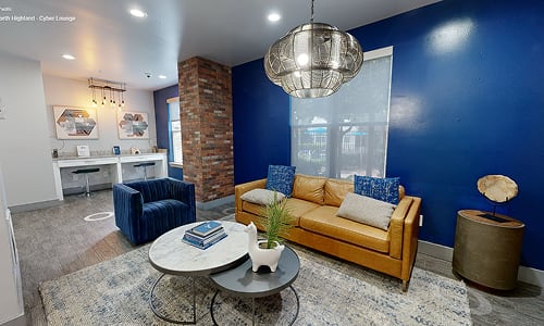 A living room with a blue couch and a coffee table.