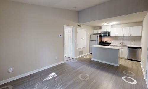 A kitchen area with a refrigerator, microwave, and oven.