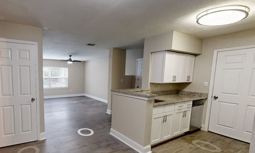 A kitchen with white cabinets and a countertop.