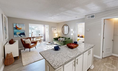 A kitchen with a granite countertop and a painting on the wall.