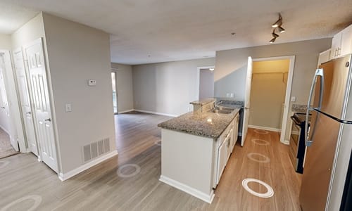 A kitchen with a granite countertop and a refrigerator.