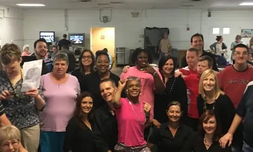 a group of people posing for a picture in a room