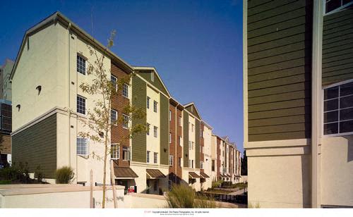 a row of houses with green and white buildings