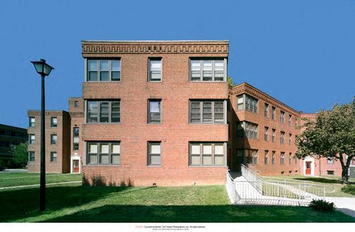 a large brick building with a staircase in front of it