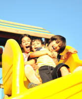 Children sliding down a slide together