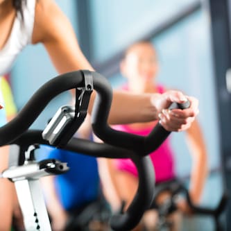 Close up of women riding on a stationary bike