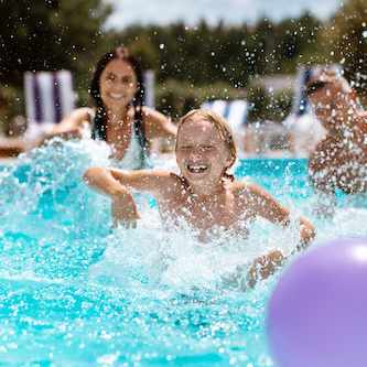 Family splashing water in a pool