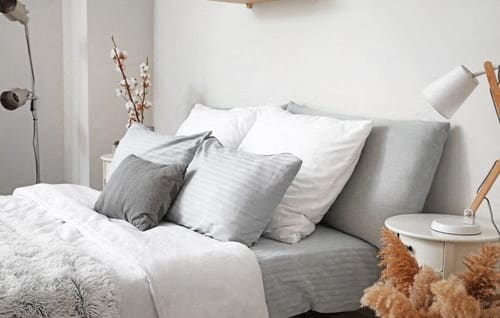a bedroom with a bed and pillows on it