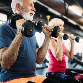 Two people lifting dumbbells
