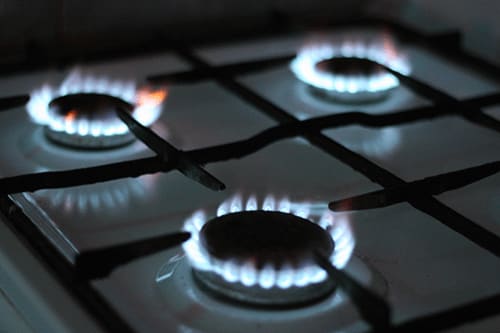 a gas stove with flames on top of it