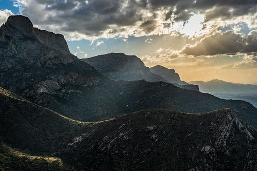 a view of the mountains and a cloudy sky