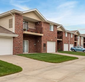 a house with two garage doors and a car parked in the driveway