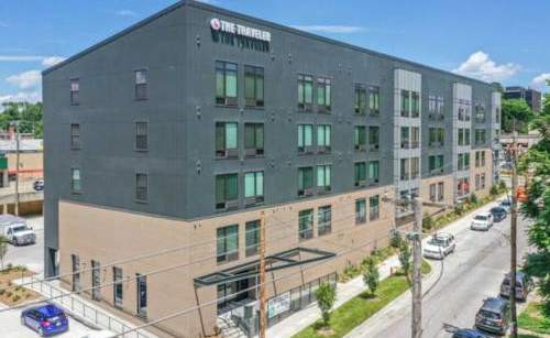 The Rampart Hotel is a large, modern building with a flat roof and a parking lot in front.