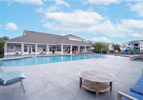 a large swimming pool with a building in the background