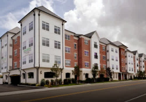An aerial view of a parking lot in front of apartment buildings.