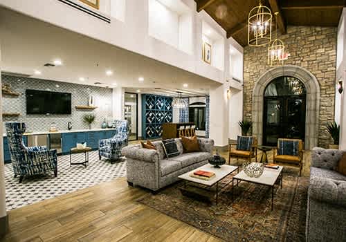 a living room with couches and chairs and a tv