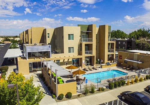 a view of the pool and the buildings at the apartments