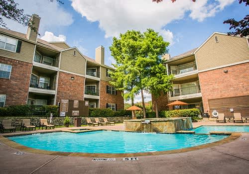 a swimming pool in front of an apartment building