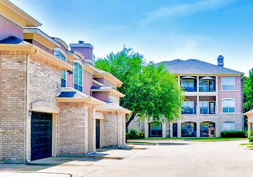 View of exterior garages and apartments at Bentley Place Apartments, Plano, TX, Texas