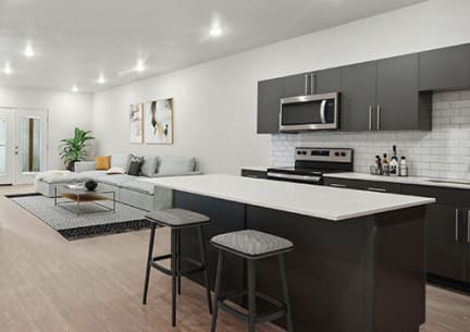Model kitchen with view of living room at Sage Valley Apartments in West Valley City, UT