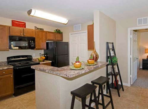 a kitchen with a counter top next to a stove top oven