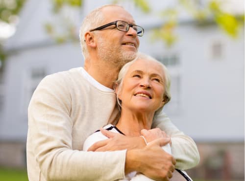 an older man embracing an older woman with their arms