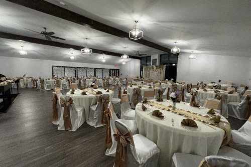 a banquet room with tables and chairs and a ceiling fan