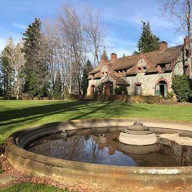 A large house with a pond in front of it.