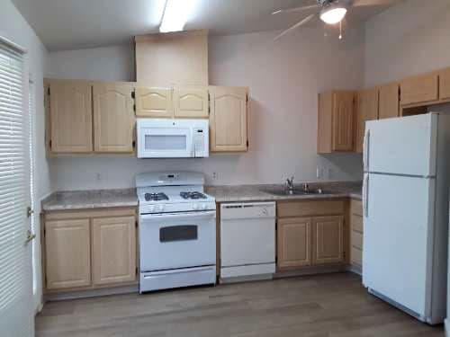 Image of refrigerator, stove, microwave, sink, cabinets, and dishwasher