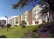 Thumbnail 3 of 5 - an image of an apartment building on a hill