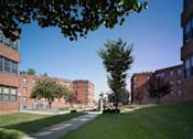 Thumbnail 2 of 4 - a view of a sidewalk between two brick buildings