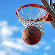 A basketball is in mid-air, about to go through the hoop.