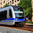A train with the number 110 on the front is on the tracks.