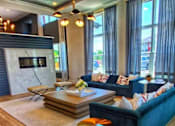 Thumbnail 16 of 17 - A modern living room with a dark blue sofa and a coffee table.